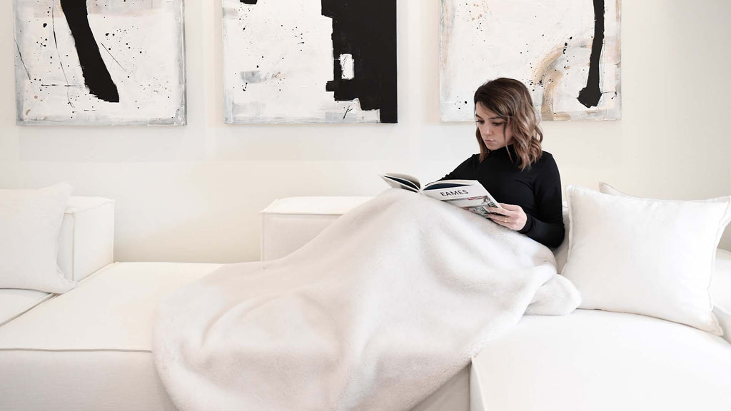 Woman Reading Book on white Ficari sofa